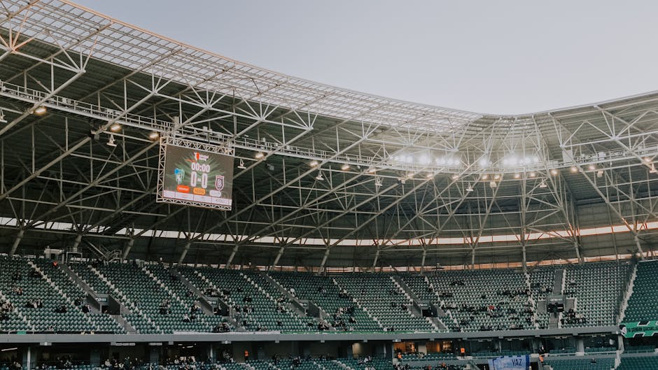 A spacious, modern sports stadium in Kocaeli, Türkiye, illuminated during sunset.