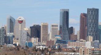 A stunning view of Calgary's skyline featuring the iconic Calgary Tower against a clear sky.