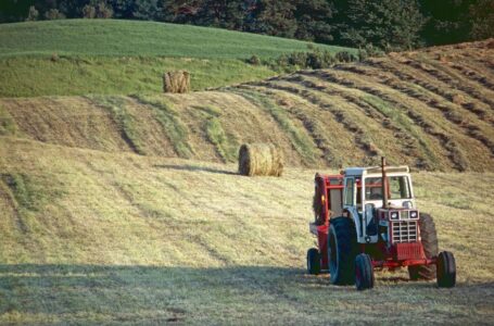 A tractor on a farm in Brant, Ontario, Canada, capturing rural life at sunset.