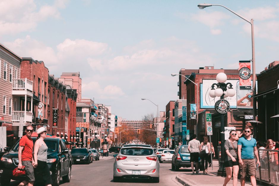 Bustling day in downtown Ottawa captures pedestrians, historic buildings, and lively street life.