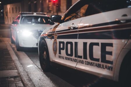 Close-up of Royal Newfoundland Constabulary police cars parked on a street at night.