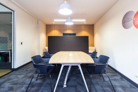 Contemporary conference room with stylish furniture and lighting, ideal for meetings.
