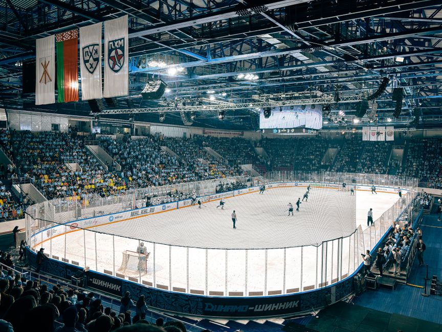 Exciting ice hockey game with players and crowd in a vibrant indoor arena atmosphere.