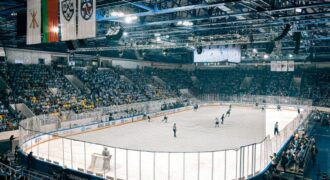 Exciting ice hockey game with players and crowd in a vibrant indoor arena atmosphere.