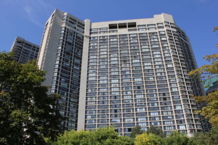 Modern high-rise residential building in Toronto under clear sky.